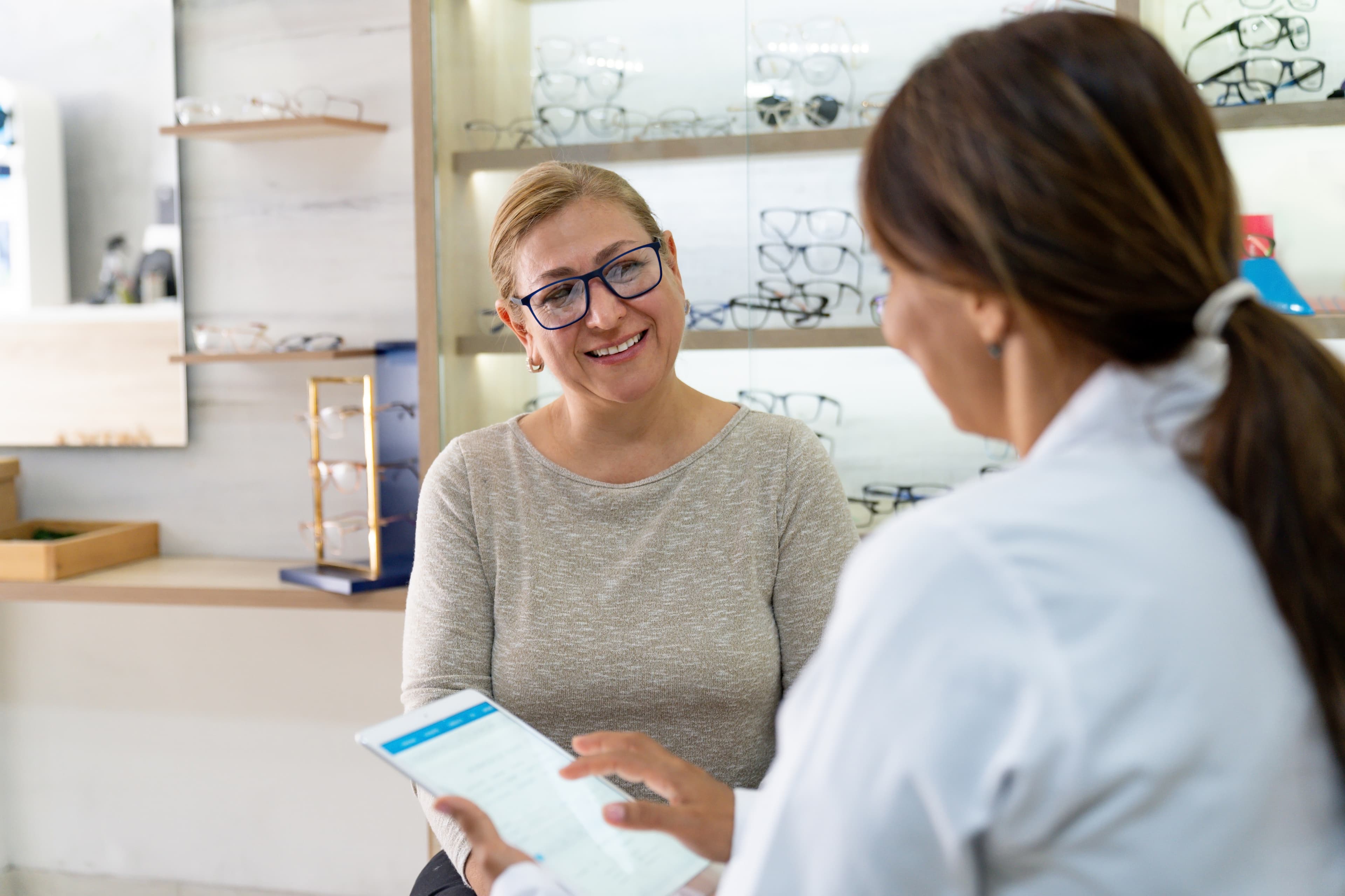 Patient speaking with an eye care professional in an optical area